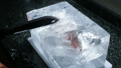 Cutting block of ice with machete saw blade Stock Footage 218465438