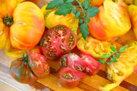 Cutting board with assorted heirloom tomatoes Stock Photos