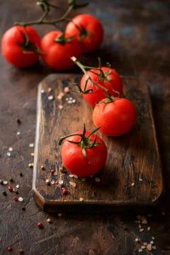 Cutting board with cherry tomatoes Stock Photos