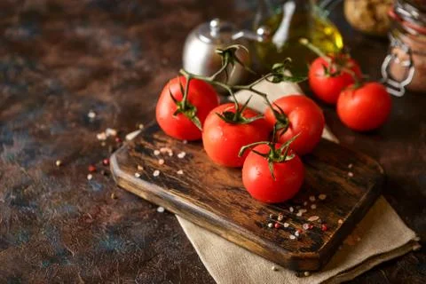 Cutting board with cherry tomatoes Stock Photos
