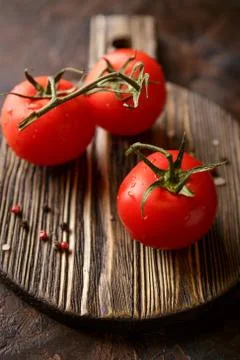 Cutting board with cherry tomatoes Stock Photos