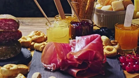 Cutting board close up, cold cuts and cheeses Stock Footage 168940540