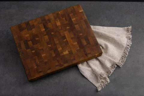 Cutting board on a grey stone table. Isolated on a black background. Culinary Stock Photos