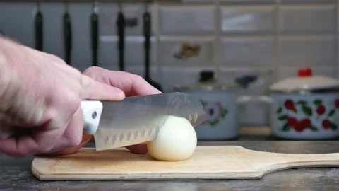 Cutting board in the kitchen, chop the onion with a knife. Stock Footage 161122460