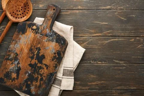 Cutting board with kitchen spoons and red napkin and parsley, tomato for cook Stock Photos