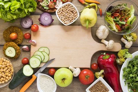 Cutting board surrounded by vegetables. High quality photo Stock Photos