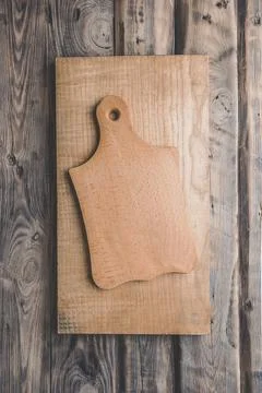 Cutting board on wood kitchen table. Food recipe concept at wood background.. Stock Photos