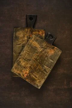Cutting boards placed on a dark surface for food preparation in a kitchen s.. Stock Photos