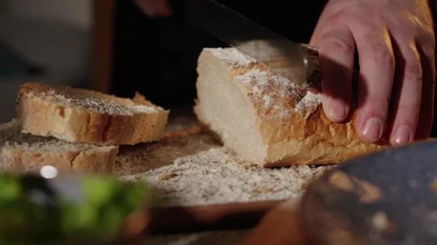 Cutting bread with breadknife in slow motion Stock Footage 254587195