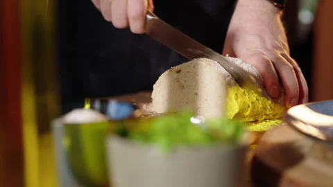 Cutting bread with breadknife in slow motion Stock Footage 254591213