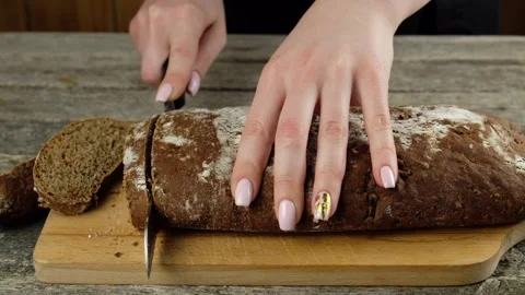 Cutting bread with a knife. Stock Footage 148527312