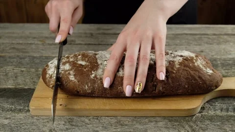 Cutting bread with a knife. Stock Footage 148527324