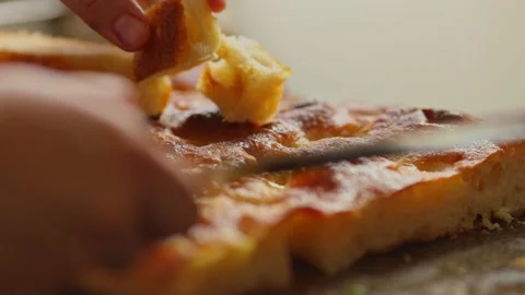 Cutting bread made from cassava flour into bite-size cubes - organic Stock Footage 166734641