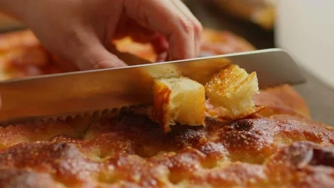 Cutting bread made from organic cassava flour into bite-size servings - Stock Footage 166836551