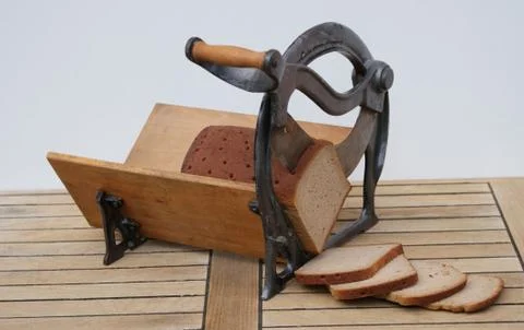 Cutting bread with an old bread slicer Stock Photos