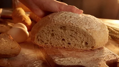 Cutting bread in slow motion Stock Footage 72252382