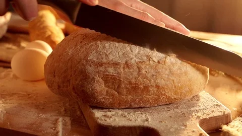 Cutting a bread in slow motion Stock Footage 72283425