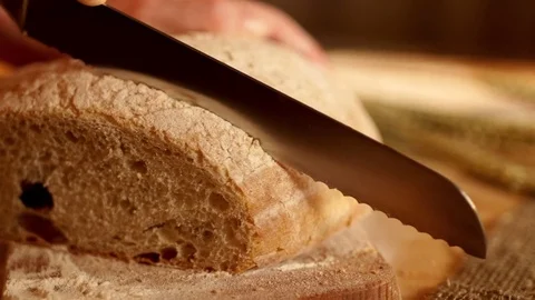 Cutting a bread in slow motion Stock Footage 72659434