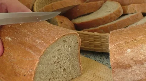 Cutting bread on wooden board Stock Footage 51786489