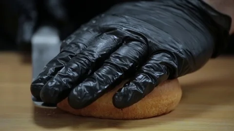 Cutting a burger bun with a sharp knife Stock Footage 127201832
