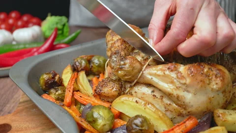 Cutting of the butcher string from a freshly baked whole chicken. Stock Footage 145118132