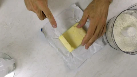 Cutting butter block into strips Stock Footage 97969406