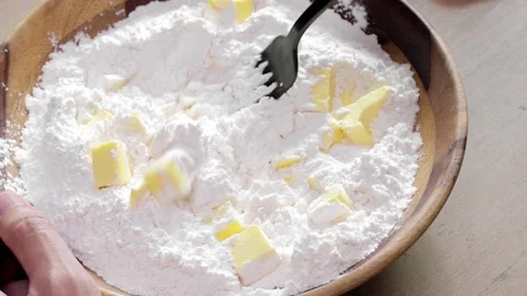 Cutting the butter into the flour to create pate brisee using a fork Stock Footage 165125219