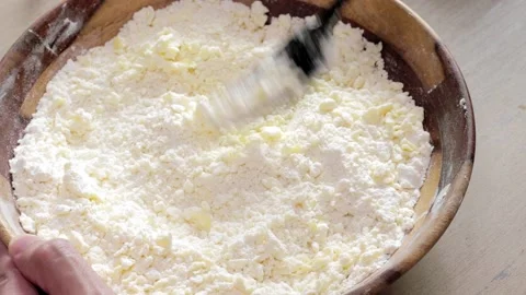 Cutting the butter into the flour to create pate brisee using a fork Stock Footage 165125257
