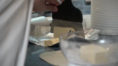 Cutting Butter in a Kitchen Stock Footage 317472573