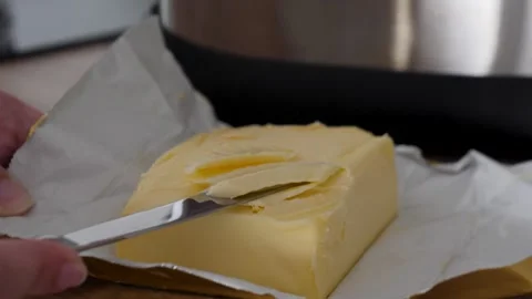 Cutting Butter from Wrapper with Knife for Cooking Stock Footage 317005742