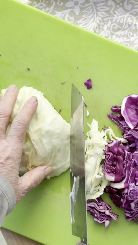 Cutting cabbage for coleslaw vertical Stock Footage 219512273