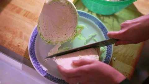 Cutting cabbage in the kitchen to prepare a salad Stock Footage 237201895