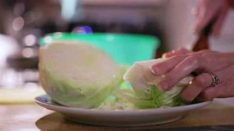 Cutting cabbage in the kitchen to prepare a salad Stock Footage 237202143