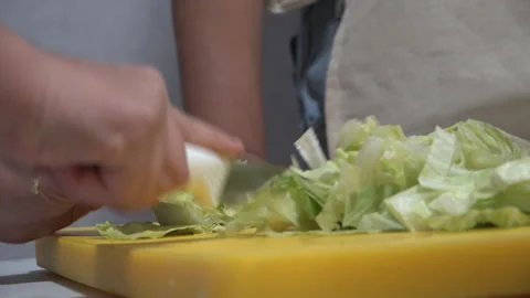Cutting cabbage with a knife in the kitchen Stock Footage 318234401