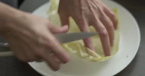 Cutting cabbage leaves for sarma dish 5.7K video Stock Footage 304369882