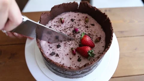 The cutting of the cake with strawberries and dark sand cake Stock Footage 142492495