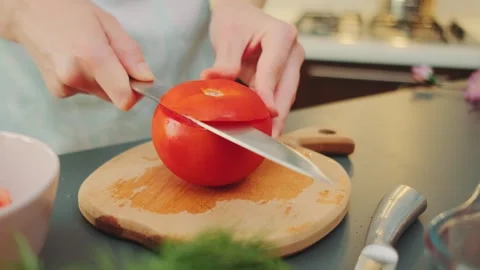 Cutting off the cap of a tomato Stock Footage 250398231