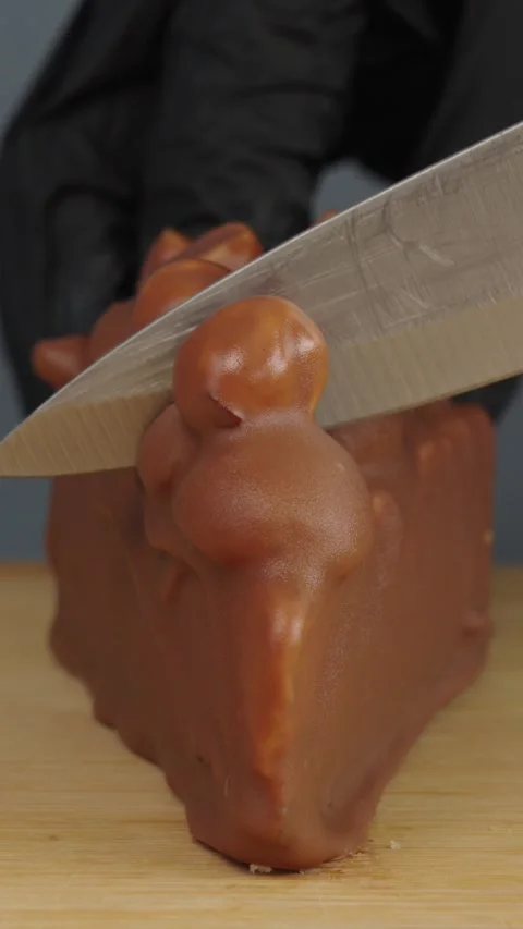 Cutting Caramel and Hazelnut Cheesecake with Kitchen Knife Close up Stock Footage 342592341
