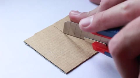 Cutting cardboard with knife Vídeos de archivo 64621988