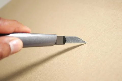 Cutting cardboard with a sharp blade for crafting project Foto stock