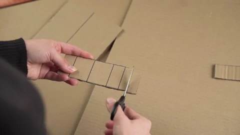 Cutting cardboard into strips with scissors Stock Footage 143236322