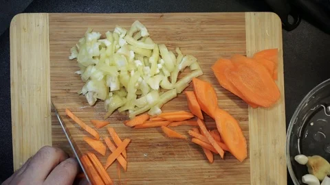 Cutting carrot overhead Stock Footage 98360653