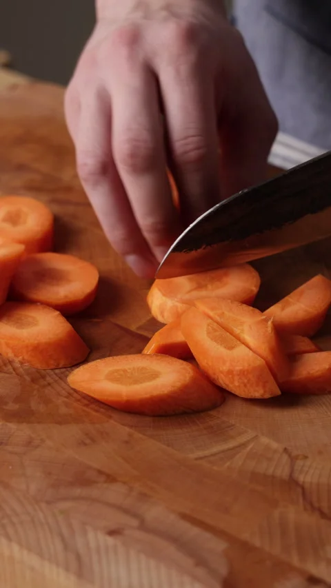 Cutting Carrot Rounds In Half Front View Vídeos de archivo 335866495