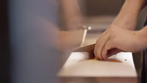 Cutting carrots with a big knife Stockbeeldmateriaal 118974728