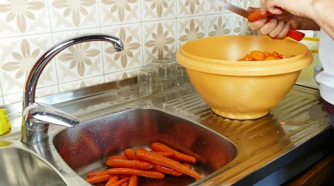 Cutting carrots in the kitchen Stock Footage 68062938