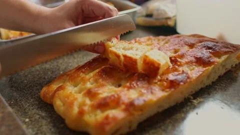 Cutting cassava bread into bite-sized cubes - ingredients harvested from Stock Footage 166734635