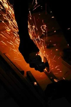 Cutting cast iron pipe with an angle grinder Stock Photos