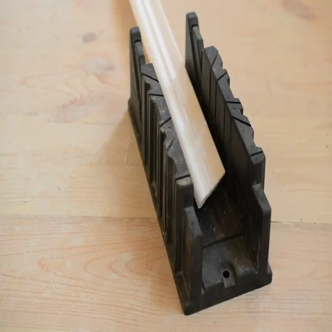 Cutting a ceiling molding in miter box Stock Footage 69443840