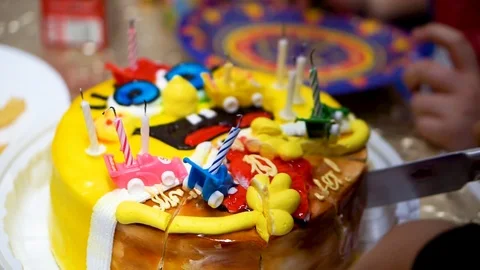 Cutting the celebratory cake with candles Stock Footage 99212844