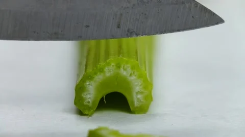 Cutting of a celery stalk into the pieces, slow motion Stock Footage 171086348